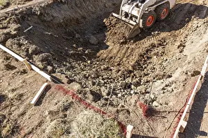 Bulldozer Construction Site Drucke: Small bulldozer digging in yard for pool installation