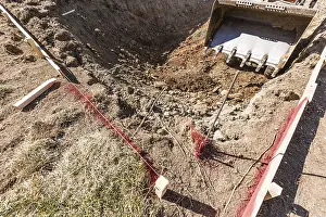 Pool Installation Process Drucke: Small bulldozer digging in yard for pool installation