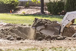Bulldozer Construction Site Drucke: Small bulldozer digging in yard for pool installation