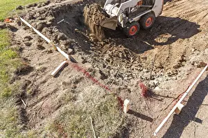 Bulldozer Construction Site Drucke: Small bulldozer digging in yard for pool installation