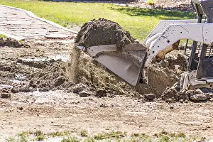 Bulldozer Construction Site Drucke: Small bulldozer digging in yard for pool installation