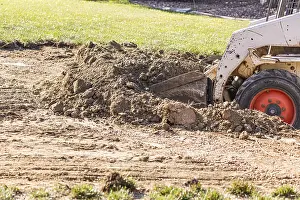 Bulldozer Construction Site Drucke: Small bulldozer digging in yard for pool installation