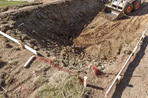 Bulldozer Construction Site Drucke: Small bulldozer digging in yard for pool installation