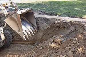 Bulldozer Construction Site Drucke: Small bulldozer digging in yard for pool installation