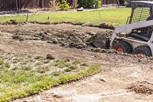 Bulldozer Construction Site Drucke: Small bulldozer digging in yard for pool installation