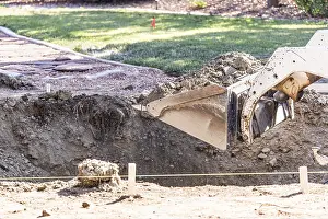 Bulldozer Construction Site Drucke: Small bulldozer digging in yard for pool installation