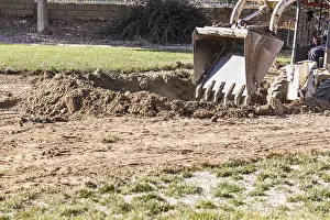 Bulldozer Construction Site Drucke: Small bulldozer digging in yard for pool installation