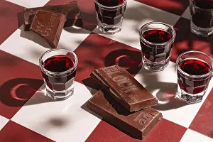 Alcoholic Beverages Drucke: There are small glasses with a red drink on the table