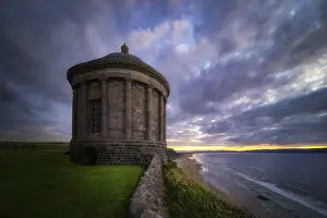 Wild Atlantic Way Photography Drucke: Small Mussenden Temple on the edge of a cliff with dramatic