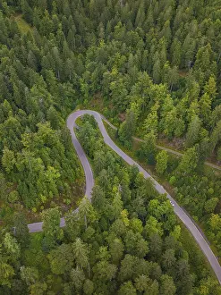European Landscape From Above Drucke: Small road winds through dense forest