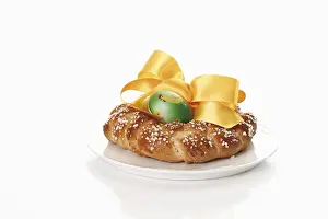 Easter Dessert Photography Drucke: Small savarin with Easter egg and bow on a plate