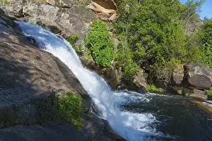 Cascada Del Diablo Spain Drucke: A small waterfall flows over large rocks