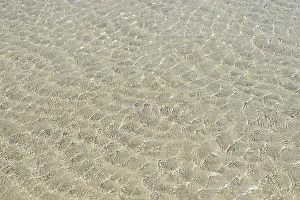 Lower Saxony Landscape Drucke: Small waves on sandy beach with light reflections