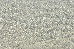 North Sea Beach Drucke: Small waves on sandy beach with light reflections