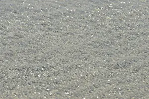 North Sea Beach Drucke: Small waves on sandy beach with light reflections