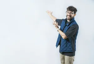 Isolated Background Image Drucke: Smiling Handsome Man Presenting something isolated