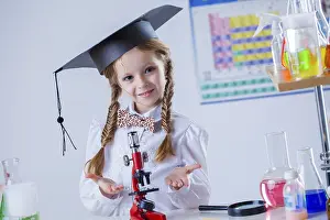 Female Researcher Drucke: Smiling little chemist posing with microscope