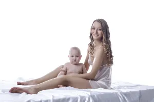 Mother And Son Drucke: Smiling lovely model posing with her son in studio