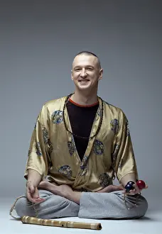 Relaxation Techniques Drucke: Smiling man doing yoga in studio in studio