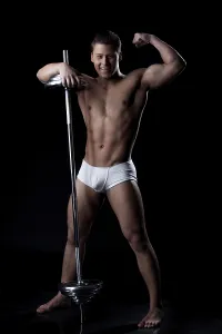 Gym Equipment Photo Drucke: Smiling strong man posing with barbell in studio
