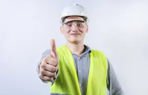 Young Engineer Drucke: Smiling young engineer gesturing approval with thumb