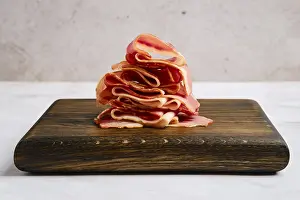 Food Photography Bacon Drucke: Smoked bacon pieces stacked in a stack