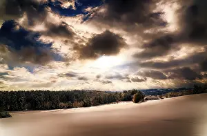 Winter Landscape Drucke: Snowy landscape with dramatic sky at sunset