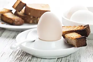 Appetizing Food Photography Drucke: The soft-boiled whole egg in an eggcup with toasted bread