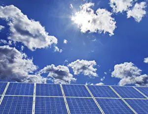 Alternative Energy Source Drucke: Solar system in front of a blue sky with clouds