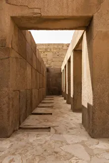 Female Figure Mythology Drucke: Solid stone columns and pillars underneath the statue of the Sphinx by Pyramids of Giza in Cairo Egypt