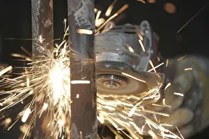 Deserted Building Site Drucke: Sparks while working with a grinder
