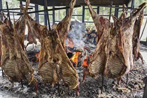 Deserted BBQ Scene Drucke: Spit-roasted mutton cooking on open fire