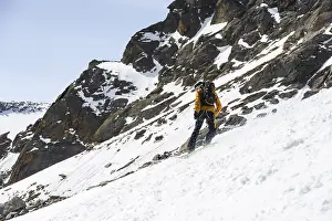 Winter Sports Drucke: Splitboarders descending a steep slope