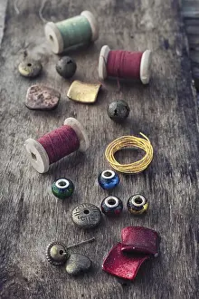 Embroidery Supplies Drucke: The spool of thread, beads and wire for needlework on wooden background