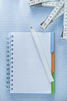 Plain Background Studio Photo Drucke: Squared notepad pencil measuring tape construction concept