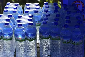 No People Waterfront Scene Drucke: Stack of blue water bottles in a stall