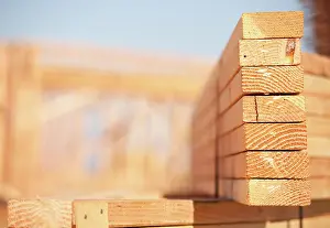 Wooden Plank Texture Drucke: Stack of Building Lumber at Construction Site with Narrow Depth of Field