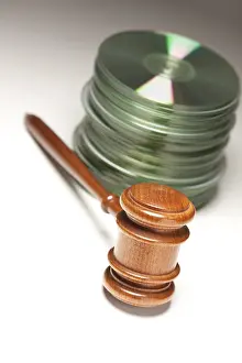 Deserted Real Estate Drucke: Stack of CD rom or DVD discs and gavel on a gradated background