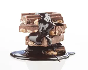 Gourmet Dessert Drucke: A stack of chocolate bars with almonds drizzled in rich