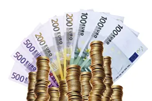 Stack Of Money Drucke: Stack of coins in front of a fan of banknotes