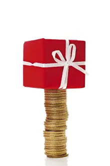 Advent Season Gifts Drucke: Stack of coins with gift parcel, present on top