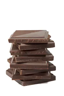 Studio Photography Food Drucke: Stack of dark chocolate isolated on white