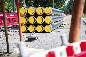 District Heating Pipes Drucke: A stack of district heating pipes on a construction site in Dusseldorf