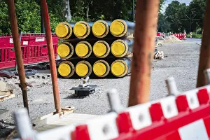 Dusseldorf Construction Site Drucke: A stack of district heating pipes on a construction site in Dusseldorf