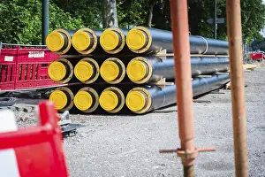 District Heating Pipes Drucke: A stack of district heating pipes on a construction site in Dusseldorf