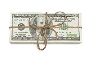 White Background Money Stack Drucke: Stack of one hundred dollar bills tied in a burlap string isolated on a white background