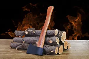 Deserted Firewood Drucke: Stack of firewood logs and axe on a wooden surface