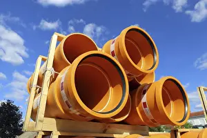 Environmental Damage Germany Drucke: Stack of KG pipes on a construction site in the Mutterstadt development area