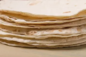 Deserted Table Setup Drucke: A stack of Mexican tortillas, on a gray table