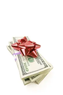 Deserted Cash Pile Drucke: Stack of money with bow isolated on a white background